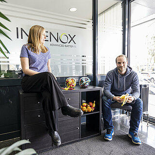 A female INVENOX employee and a male INVENOX employee taking a break together