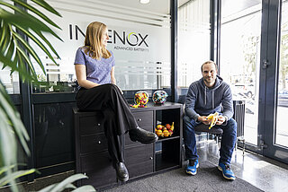 A female INVENOX employee and a male INVENOX employee taking a break together